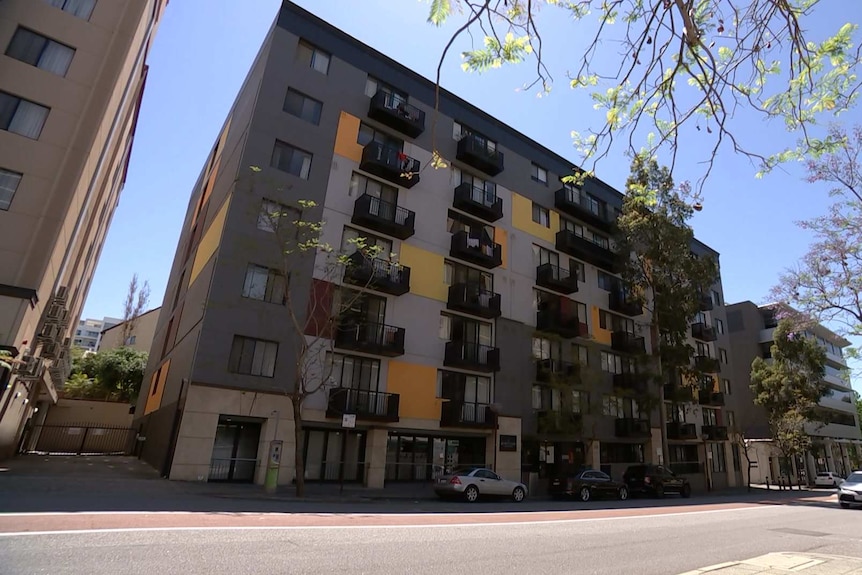 A photo of the painted grey exterior of an apartment complex in East Perth.