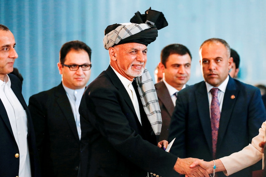 Afghan presidential candidate Ashraf Ghani arrives to cast his vote in the presidential election in Kabul.