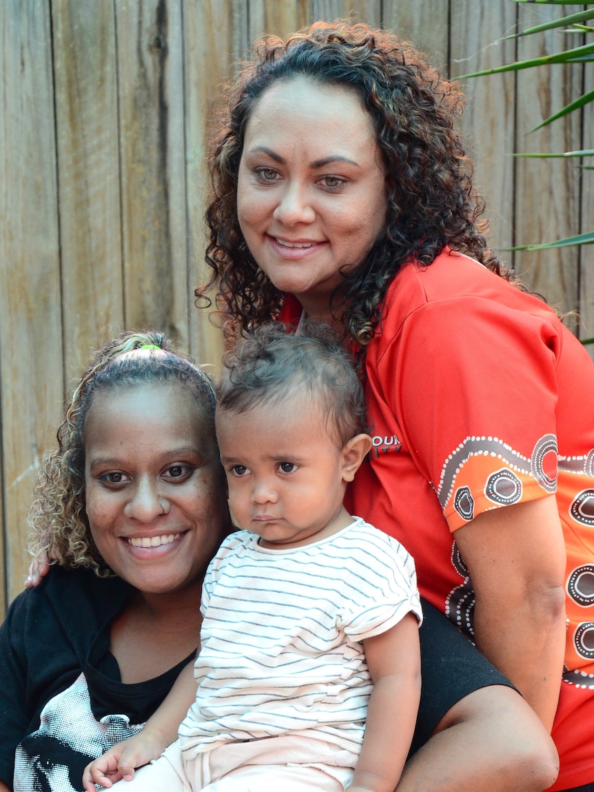 Image of Mackapilly Sebasio and her youngest child Sunnie with BiOC South Program Manager Courtney Law