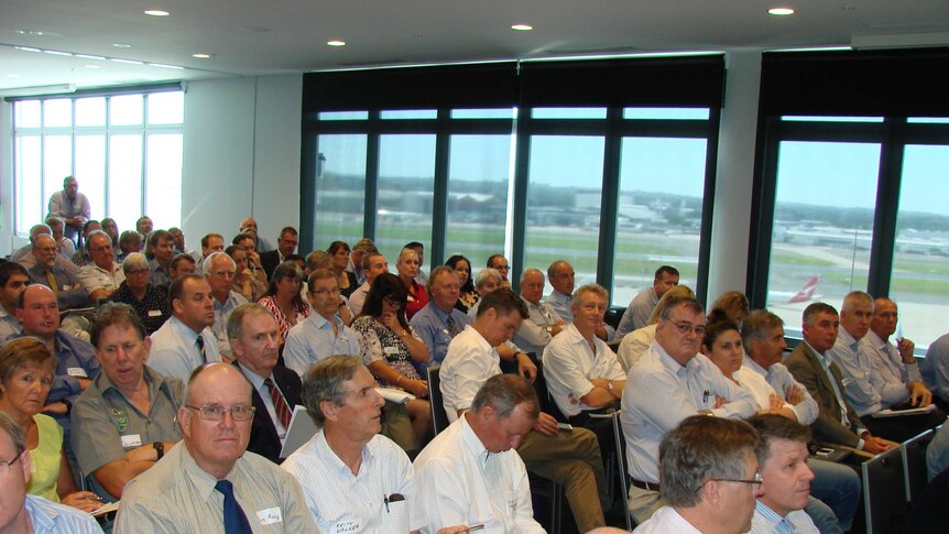 Meeting room with 100 people discuss bovine Johne's disease management