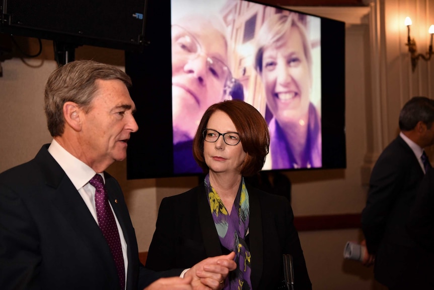 Former Victorian premier John Brumby and former prime minister Julia Gillard at the memorial service for Fiona Richardson.