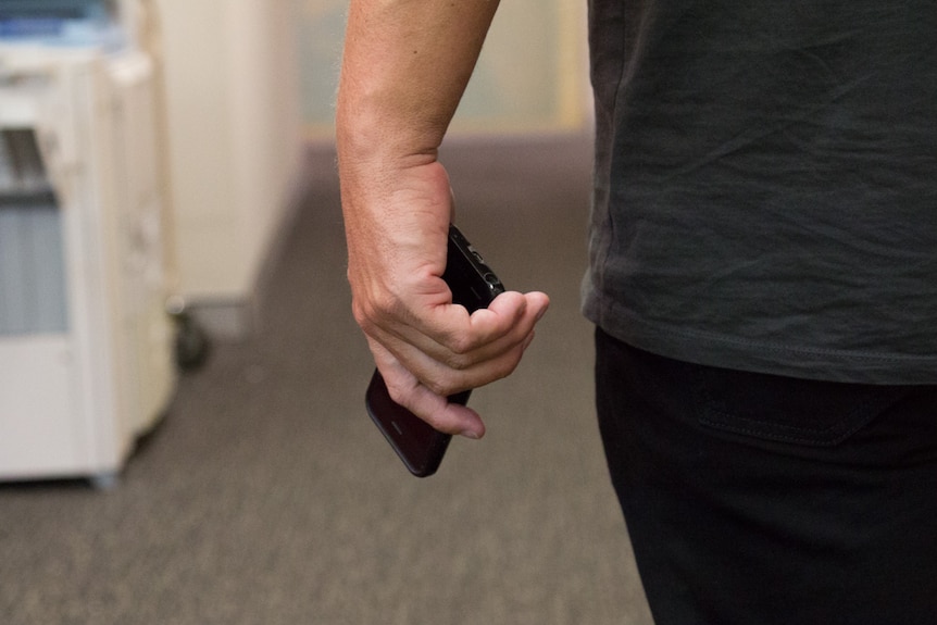 A man holds a smartphone in his hand