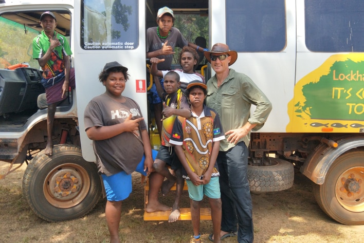 Students posing in the door of a school bus.