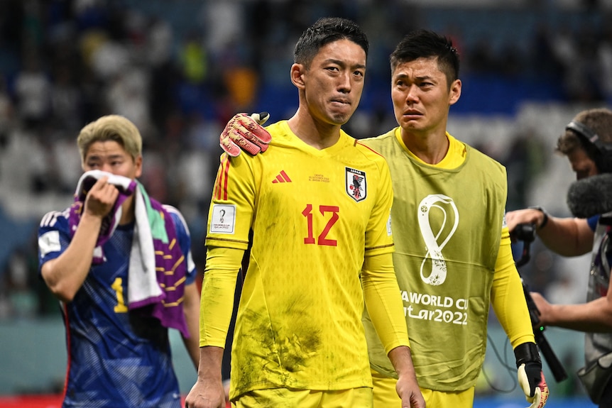 Japan's Shuichi Gonda and Eiji Kawashima look dejected after a penalty shootout.