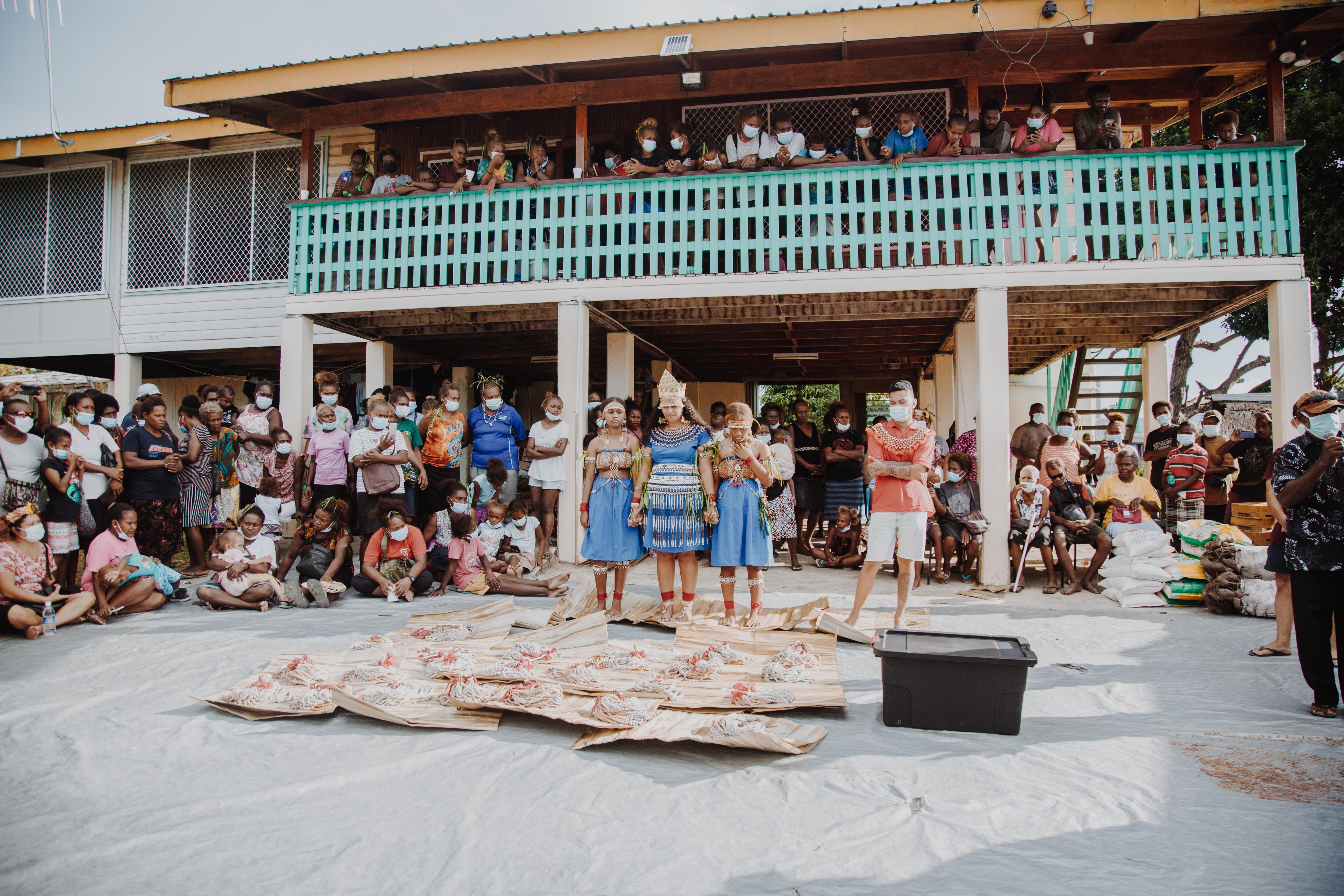 A young woman stands with her cousins ​​during a bride price ceremony in Solomon Islands