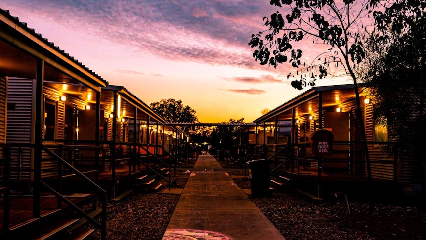 A photo of the Howard Springs quarantine facility — a former workers camp — at sunset.