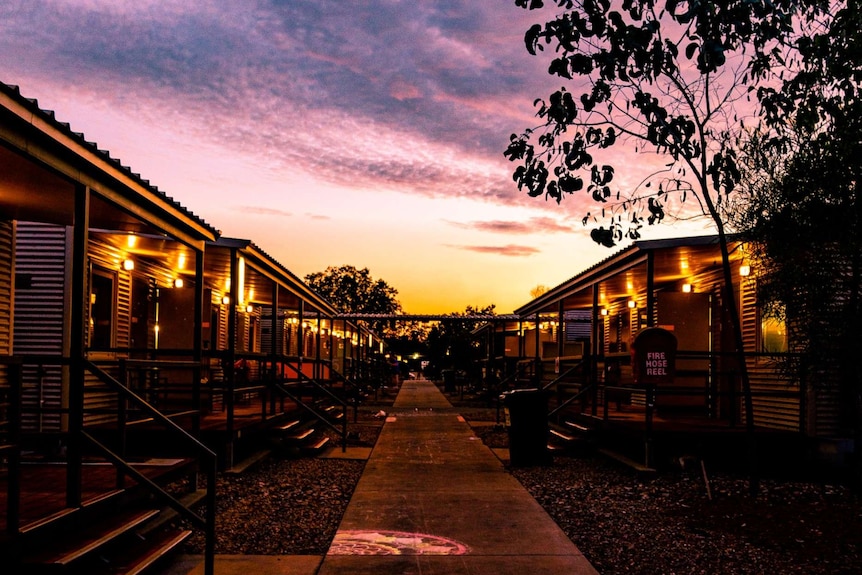 A photo of the Howard Springs quarantine facility — a former workers camp — at sunset.