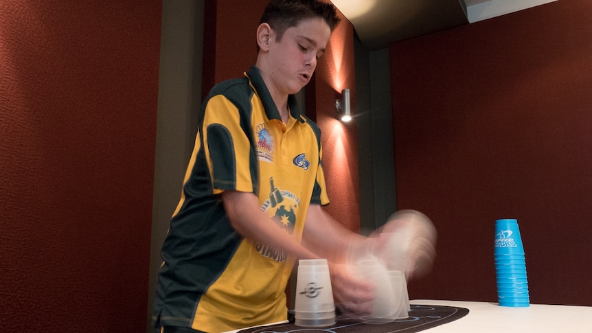 13-year-old Jaydyn Coggins practices his sports stacking.