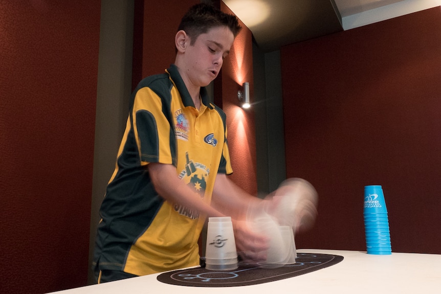 13-year-old Jaydyn Coggins practices his sports stacking.