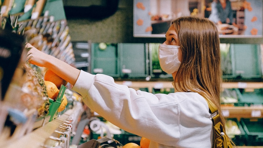 A woman wearing a mask while shopping