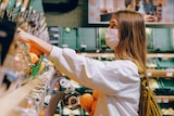 A woman wearing a mask while shopping