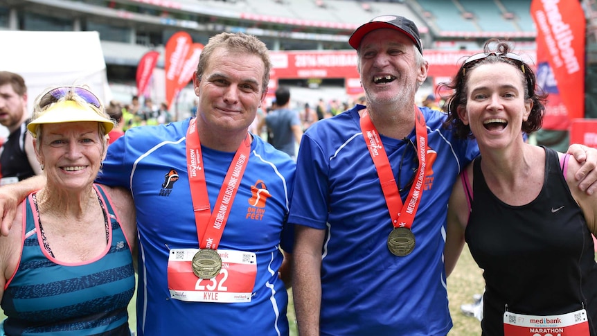 Shirley Bell, Kyle Holtzman, Ian Brown and Shona MacDonald pose for a photo after the Melbourne Marathon.