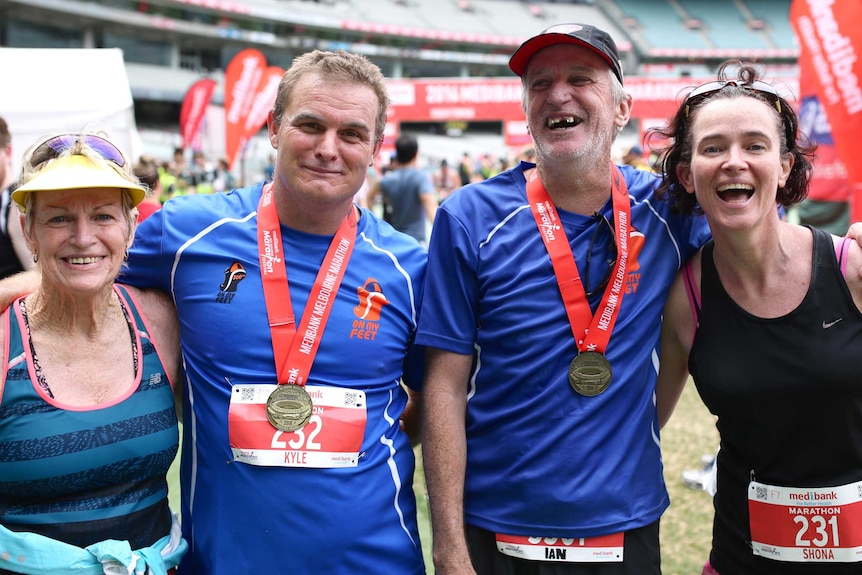 Shirley Bell, Kyle Holtzman, Ian Brown and Shona MacDonald pose for a photo after the Melbourne Marathon.