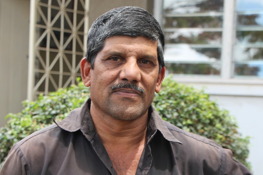 A farmer standing in front of a building