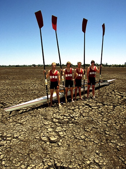 Rowers stand in a dry lake in Ballarat