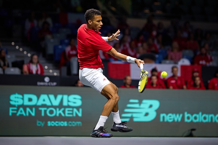 Felix Auger-Aliassime plays a shot