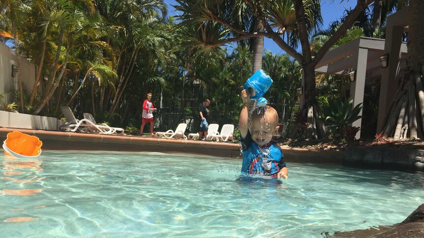 A toddler playing in a pool in Queensland
