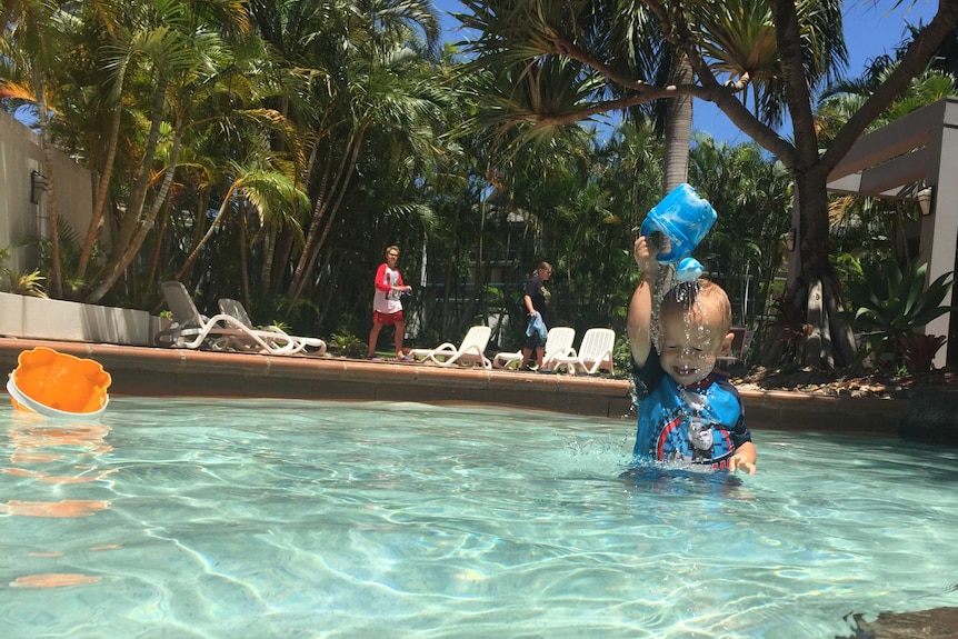 A toddler playing in a pool in Queensland