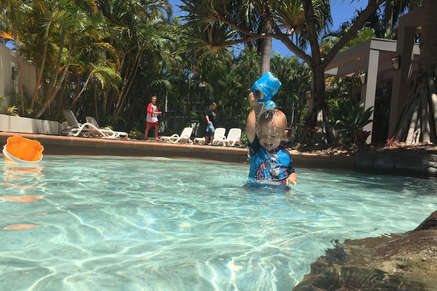 Baby Leo splashes in the water on a hot day