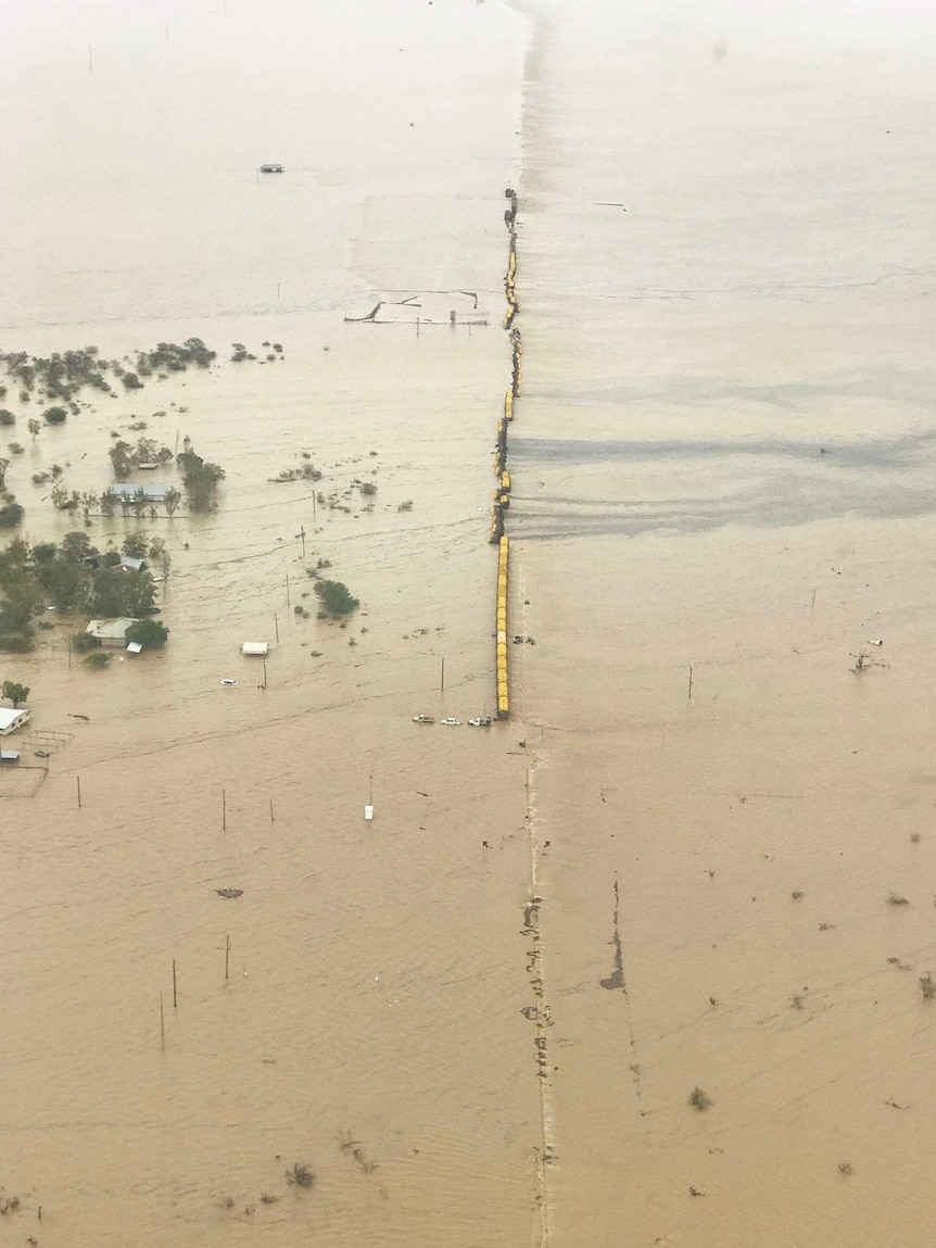 Aerial image of freight train stranded on a flooded plain
