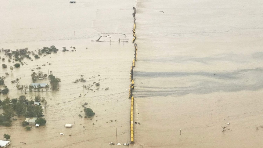 Aerial image of freight train stranded on a flooded plain