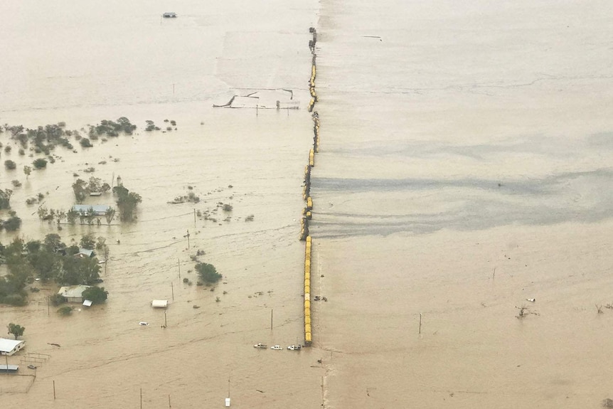 Aerial image of freight train stranded on a flooded plain