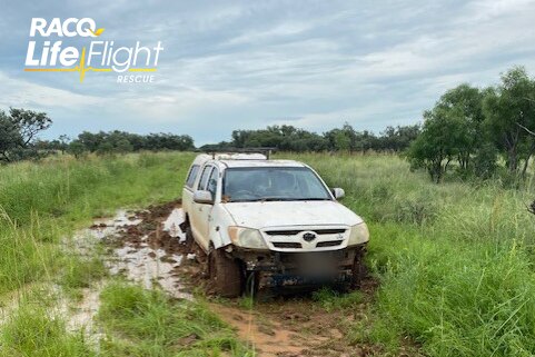 A ute bogged in mud.