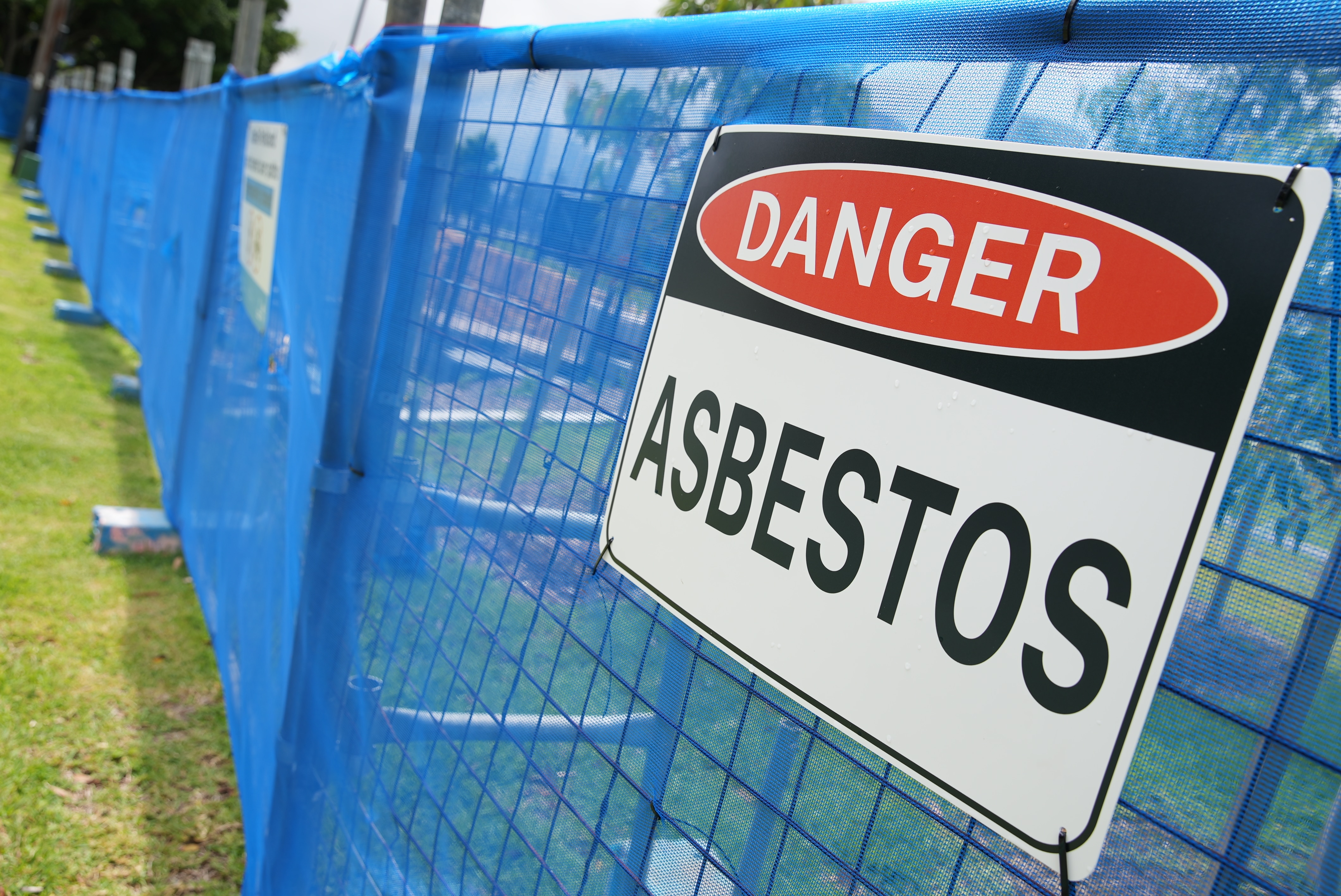 Fence with a danger asbestos sign at the Rozelle Parklands as the clean up continues