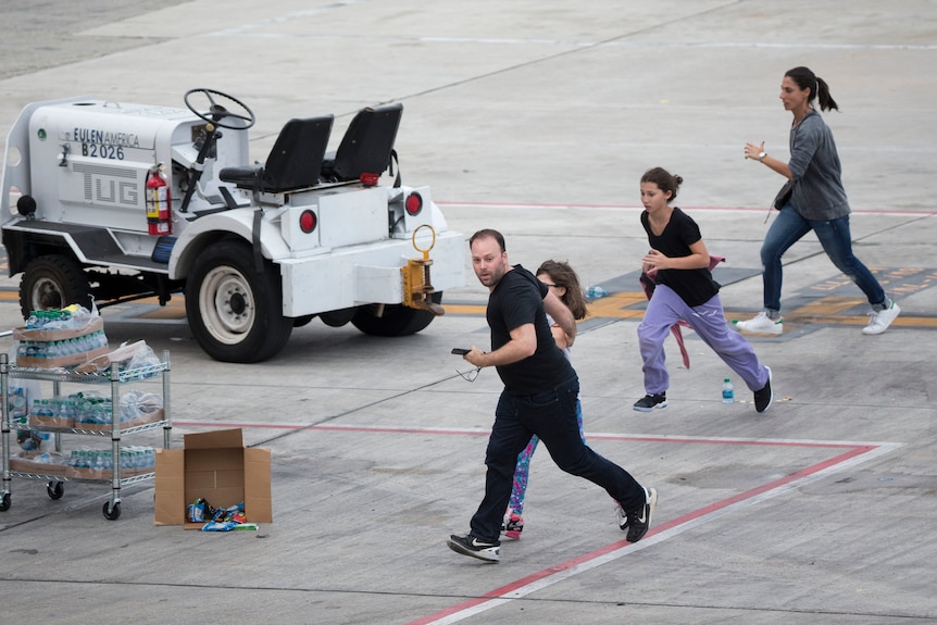 People run on the tarmac at Fort Lauderdale airport