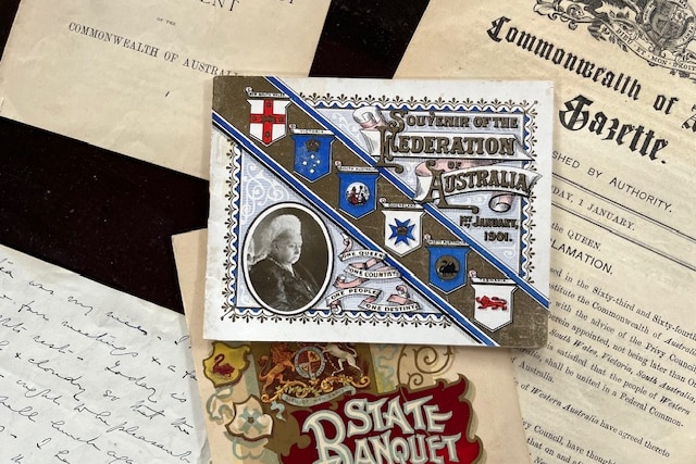 a postcard commemorating the federation of Australia in 1901 amongst other old papers 