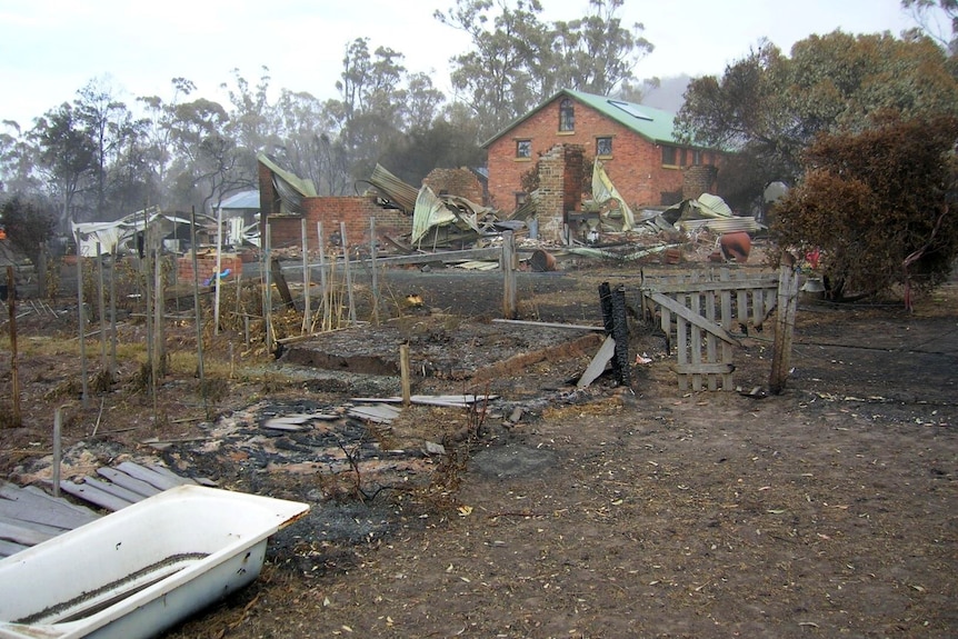 A brick building still stands after a bushfire destroyed other buildings around it 
