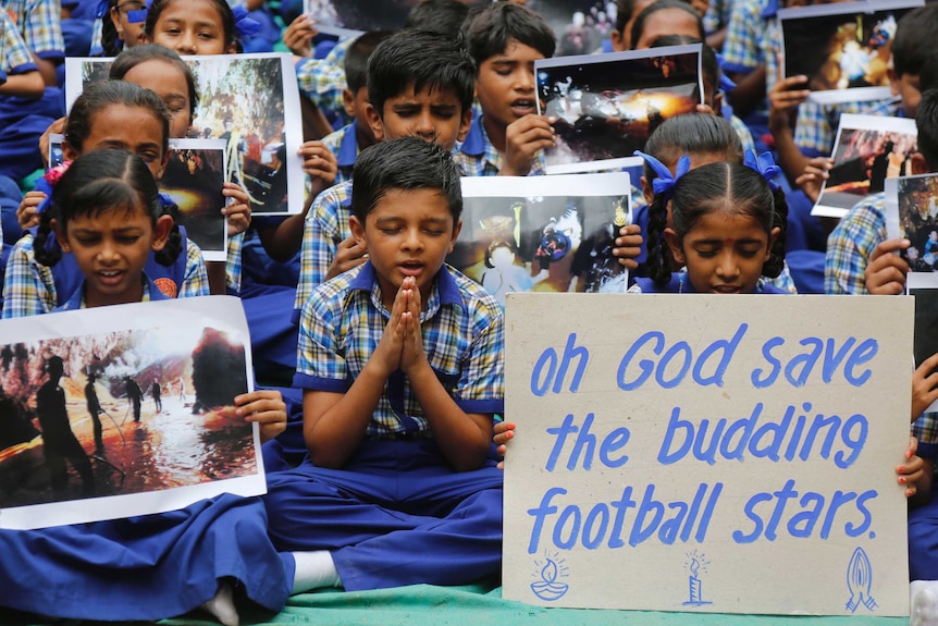 Indian students pray for Thai boys stuck in cave