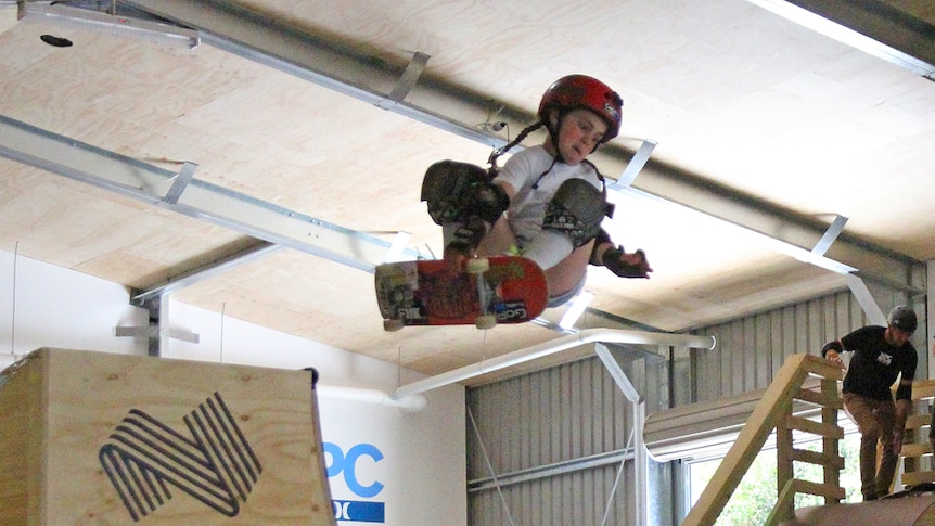 Young surfer Quincy Symonds takes to the air on a skateboard