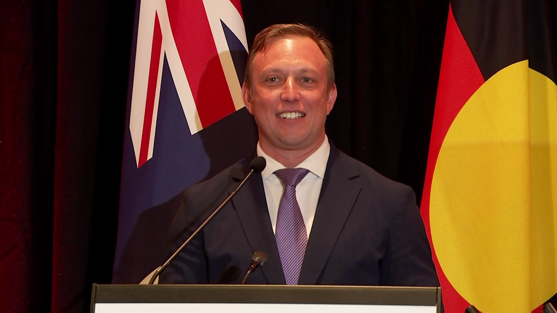 Steven Miles addresses the crowd from a podium