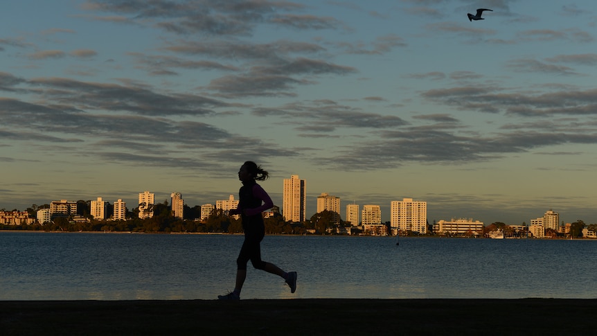 Woman runs around the Swan River in Perth