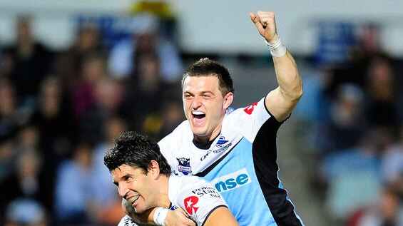 Match winner: Trent Barrett and Nathan Gardner celebrate the Sharks' win deep into extra-time.