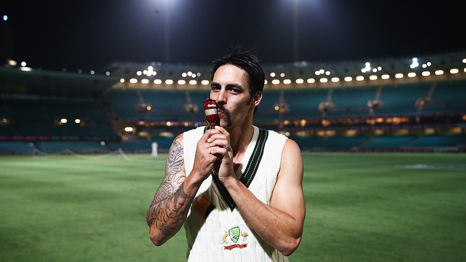 Mitchell Johnson of Australia poses with the Ashes Urn on the pitch at midnight after day three of the Fifth Ashes Test match.