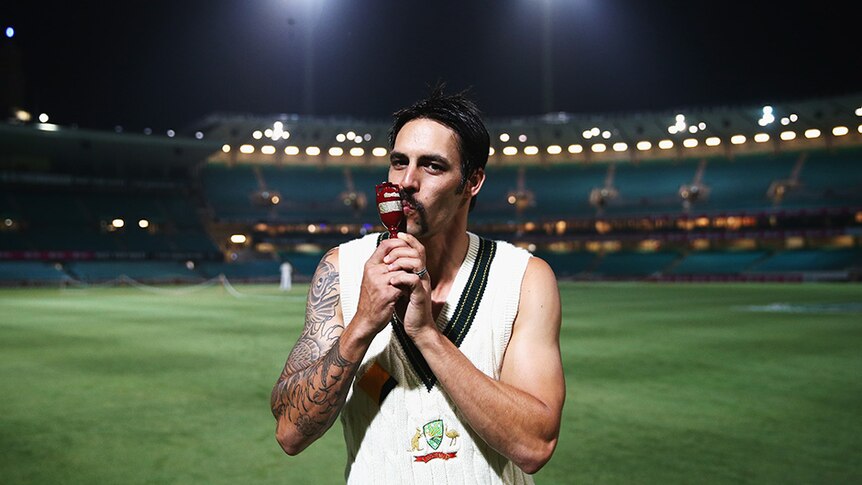 Mitchell Johnson of Australia poses with the Ashes Urn on the pitch at midnight after day three of the Fifth Ashes Test match.