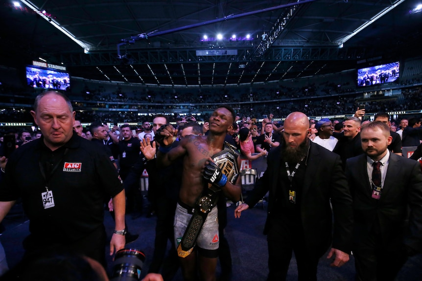Israel Adesanya celebrates with the fans