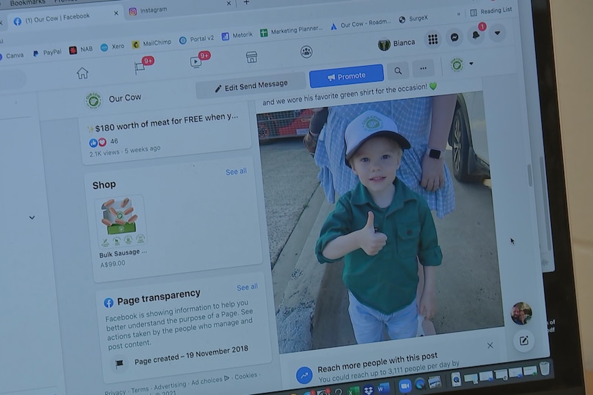 An image of a Facebook page on a laptop, featuring a photo of a young boy giving a thumbs up.