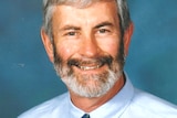 Photograph of Bob Montgomery in tie and blue shirt smiling
