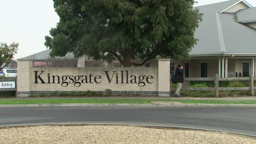 Image of a stone gate with the words Kingsgate Village on it