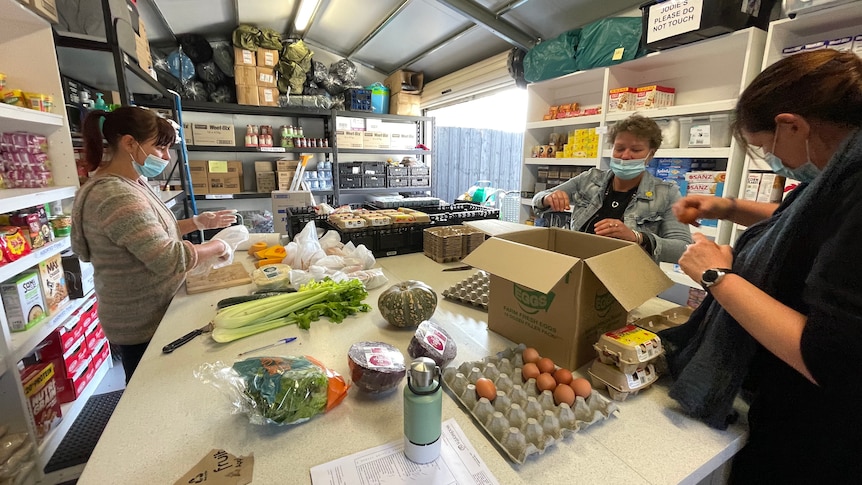 Three women prepare food packages at the Bunker at Community Support Frankston