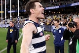 Jeremy Cameron clenches both fists and yells in delight while walking off the MCG