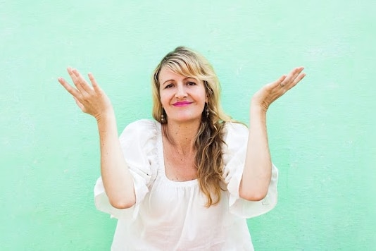 a woman with her hands up in the air.