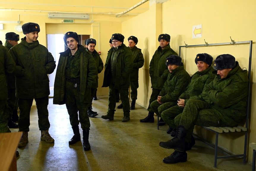 Army recruits in a room in Rostov-on-Don gather to receive their winter uniforms