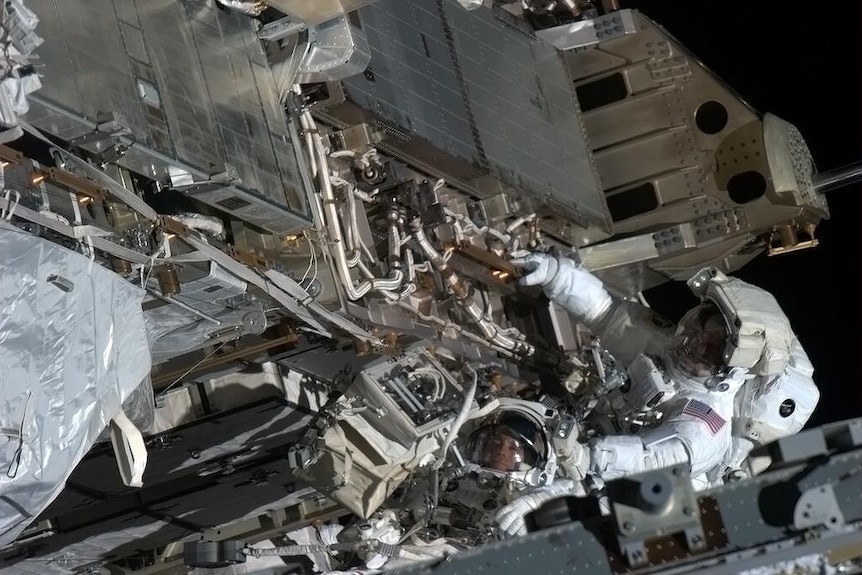 Astronauts making a space walk.