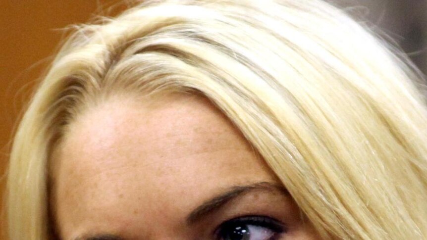 Lindsay Lohan looks on impassively in court