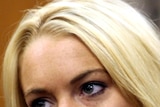Lindsay Lohan looks on impassively in court