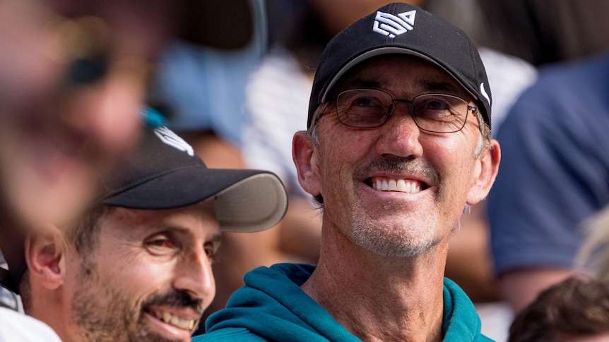 Darren Cahill smiles as he looks on in the stands at the 2024 Australian Open.